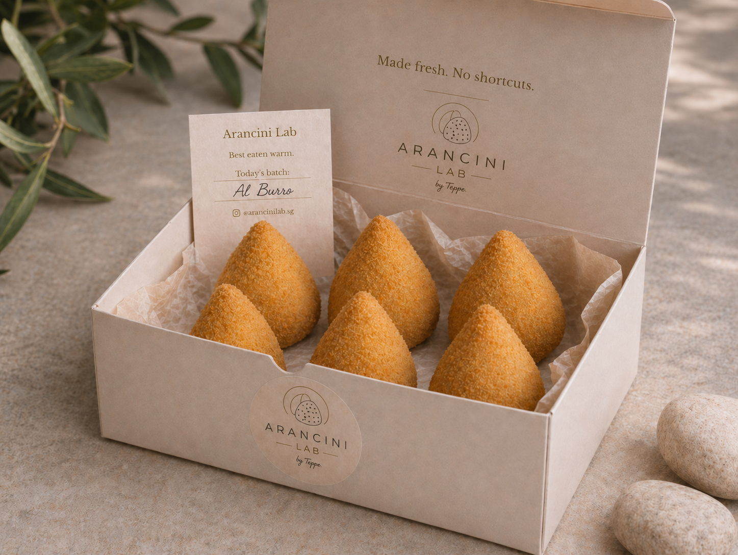 Box of cone-shaped Al Burro arancini from Arancini Lab